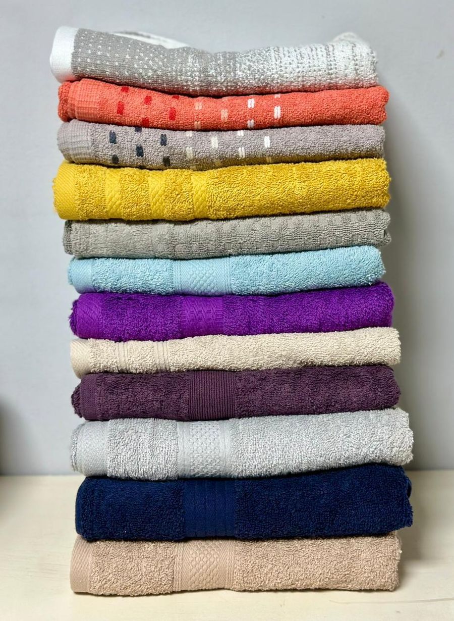 Stack of folded bath towels in assorted colours