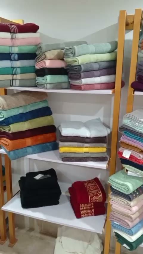 Real factory photo: inspected towel stock organised on warehouse shelving